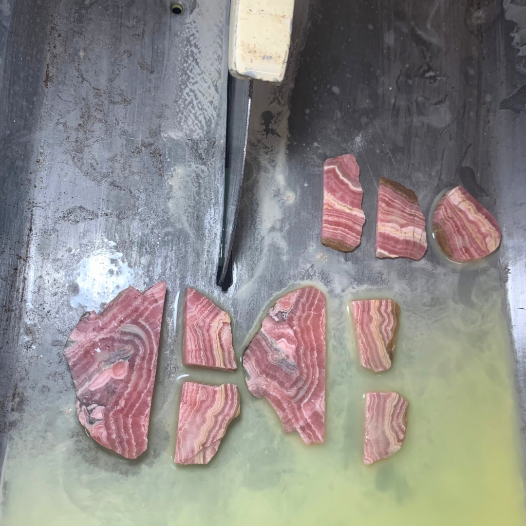 Ray of Sunshine Jewellery - at the saws, me cutting Rhodochrosite slabs into shapes ready for carving