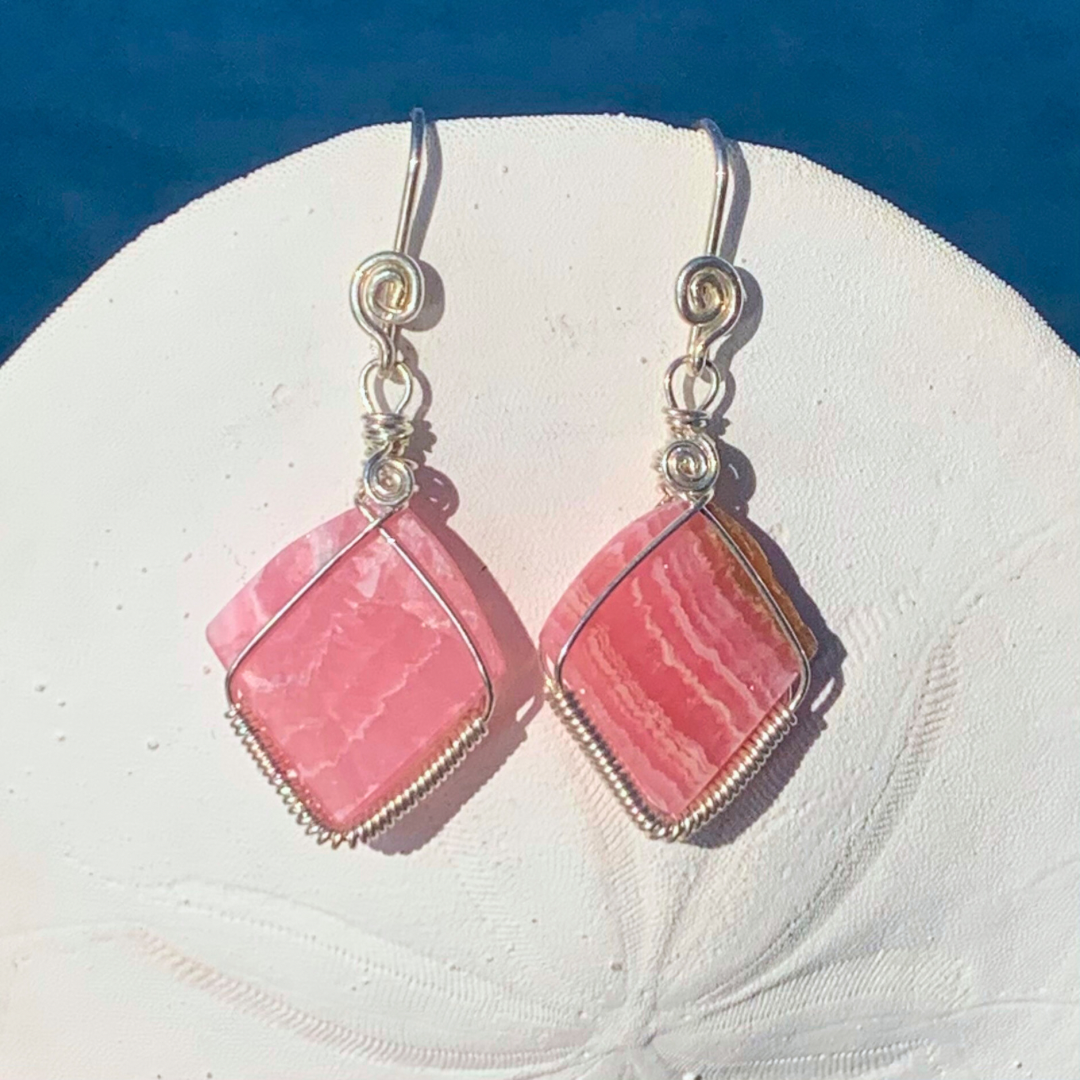 Ray of Sunshine Jewellery - stunning pink gemstones hand carved by me wrapped in Sterling Silver and hanging from a sand dollar shell