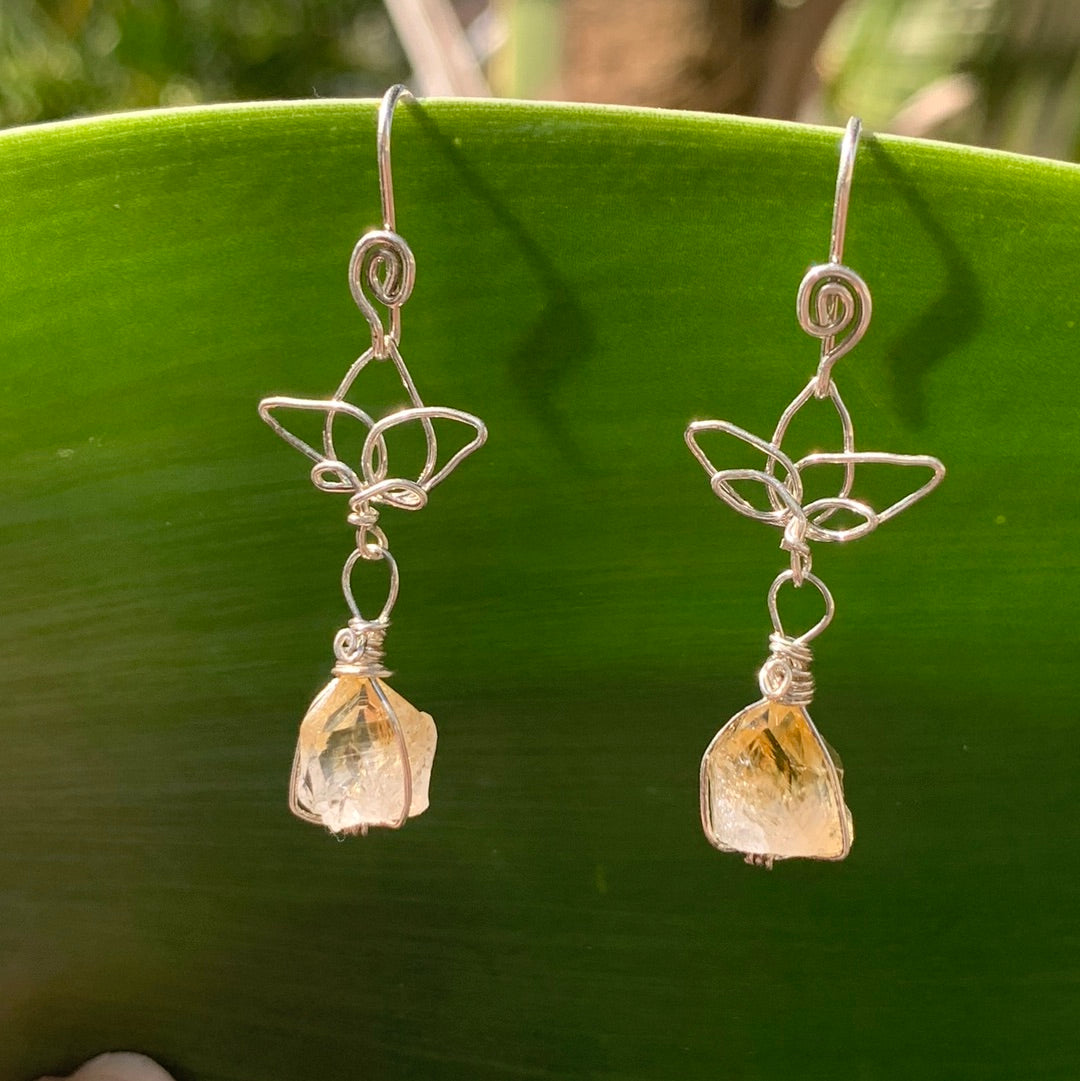 Ray of Sunshine Jewellery- Sterling Silver earrings with Lotus Flower designs and golden Citrine gemstones on a green agave leaf background