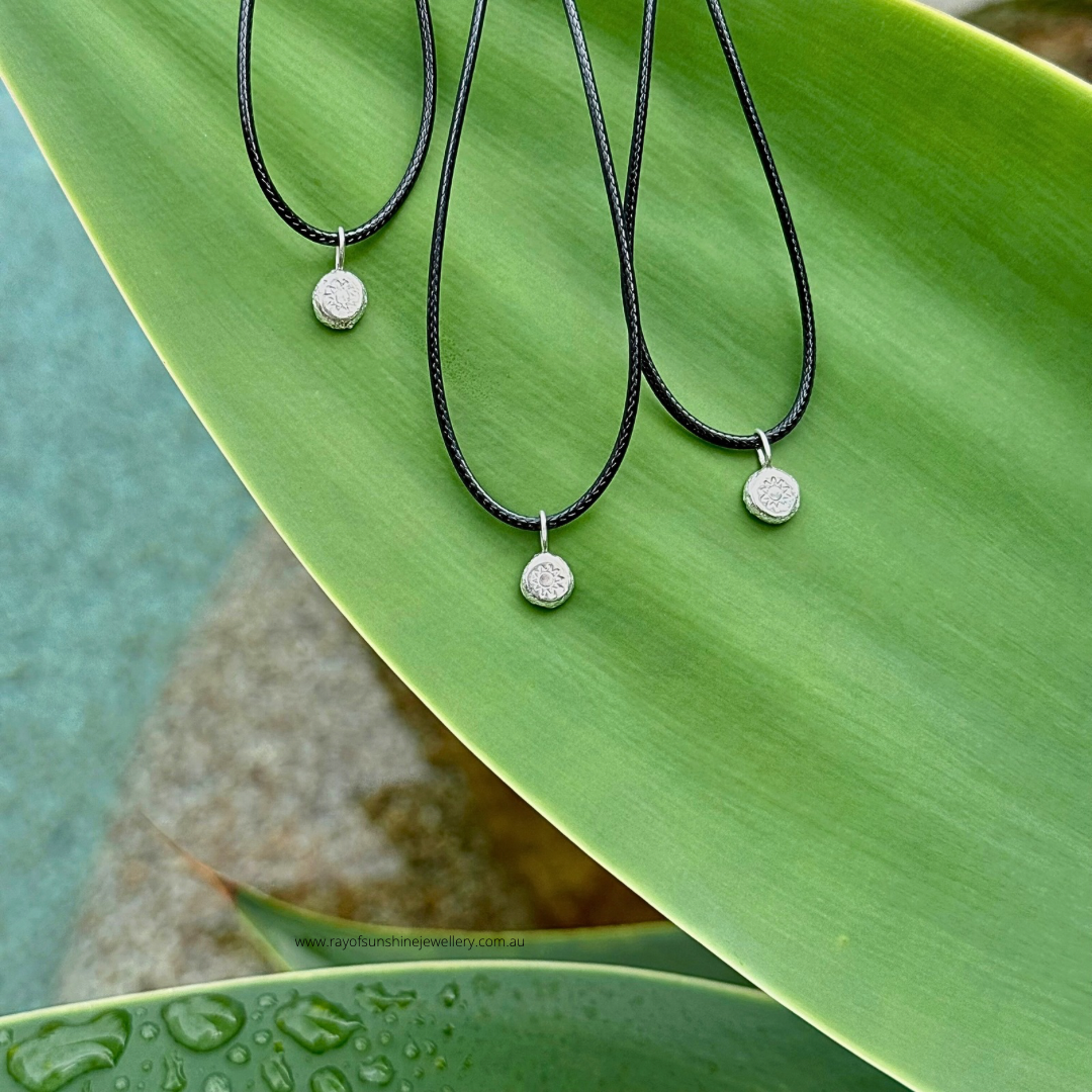 Ray of Sunshine Jewellery - 3 dollops of sunshine necklaces sitting on a large green leaf