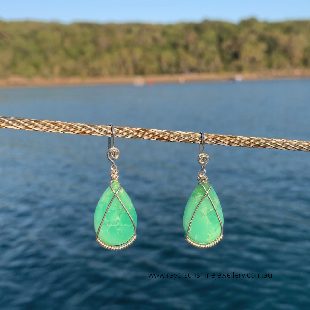 Ray of Sunshine Jewellery- Apple-Green teardrop earrings on a wire against a blurred natural background