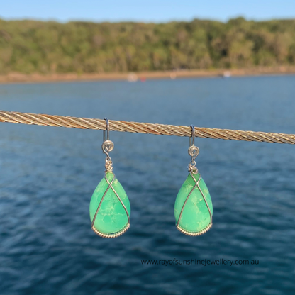 Ray of Sunshine Jewellery- Apple-Green teardrop earrings on a wire against a blurred natural background