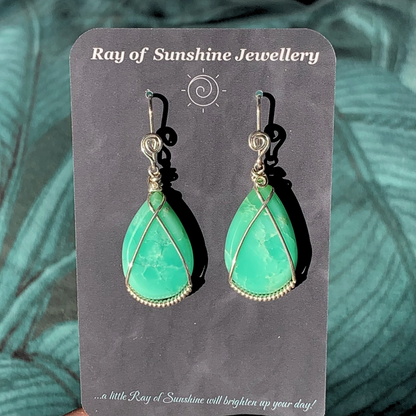 Ray of Sunshine Jewellery- Apple Green Chrysoprase teardrop earrings on a 'Ray of Sunshine Jewellery' business card with a green leafy background.