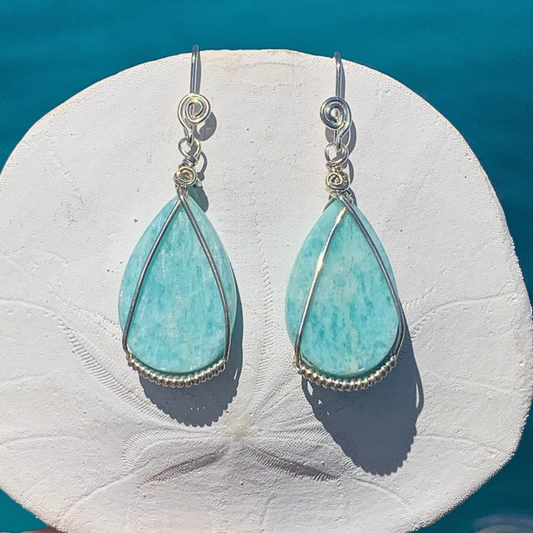 Ray of Sunshine Jewellery- these gorgeous earrings are hanging on a sand dollar shell in the sunshine over turquoise waters of Lady Musgrave Island