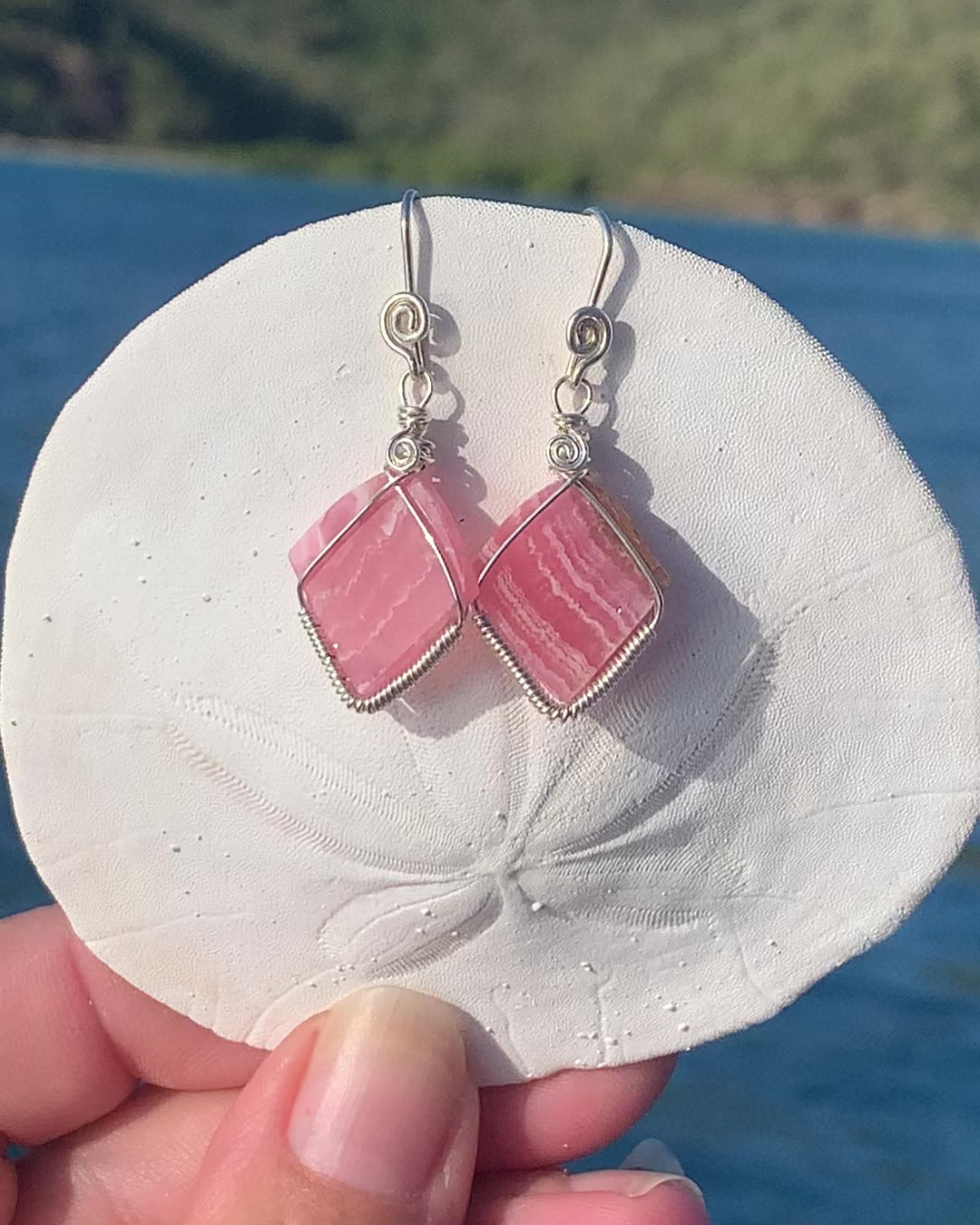Ray of Sunshine Jewellery - stunning pink gemstones hand carved by me wrapped in Sterling Silver and hanging from a sand dollar shell