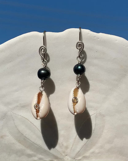 Ray of Sunshine Jewellery- earrings are dancing in the sunlight and hanging from a white sand dollar shell with lovely blue sky in the background