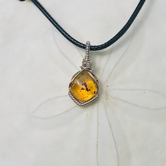 RAY OF SUNSHINE JEWELLERY - this beautiful amber stone has tiny black bugs and parts captured within the golden hues and in the sunshine she simply glows