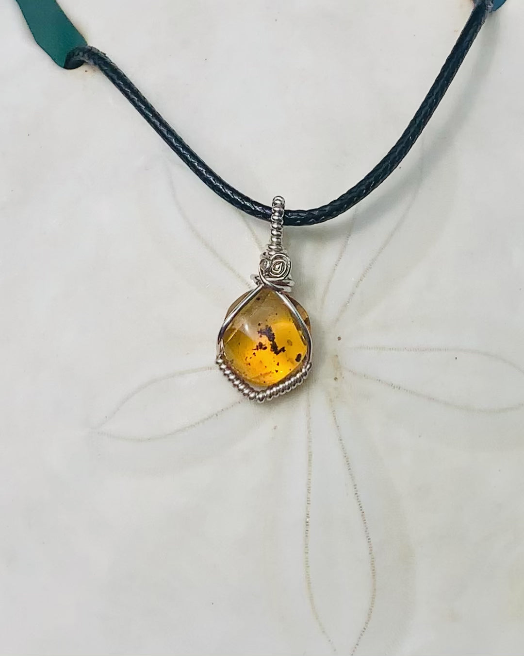 RAY OF SUNSHINE JEWELLERY - this beautiful amber stone has tiny black bugs and parts captured within the golden hues and in the sunshine she simply glows
