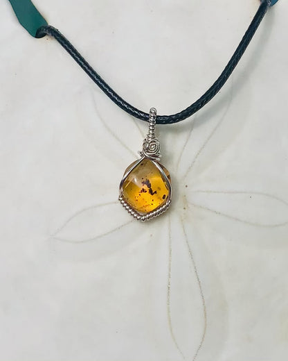 RAY OF SUNSHINE JEWELLERY - this beautiful amber stone has tiny black bugs and parts captured within the golden hues and in the sunshine she simply glows
