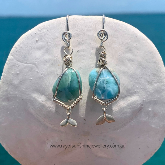 Ray of sunshine jewellery - these gorgeous tumbled stones with their blue swirls are hugged in sterling silver and hang from a sand dollar shell in the sunshine over the ocean